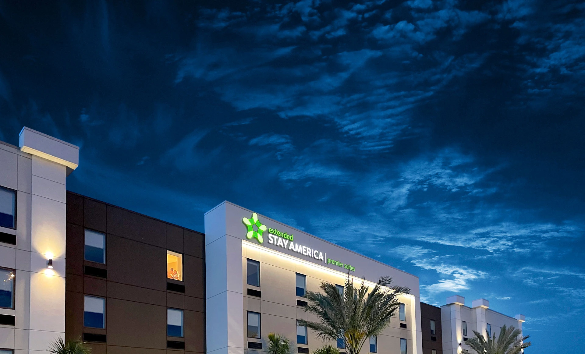 Exterior of Extended Stay America Premier suites hotel with blue sky