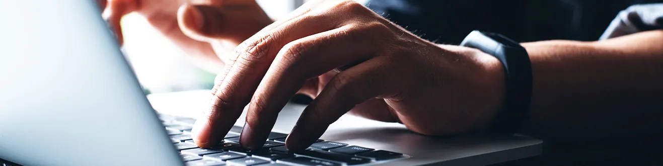 person typing on keyboard